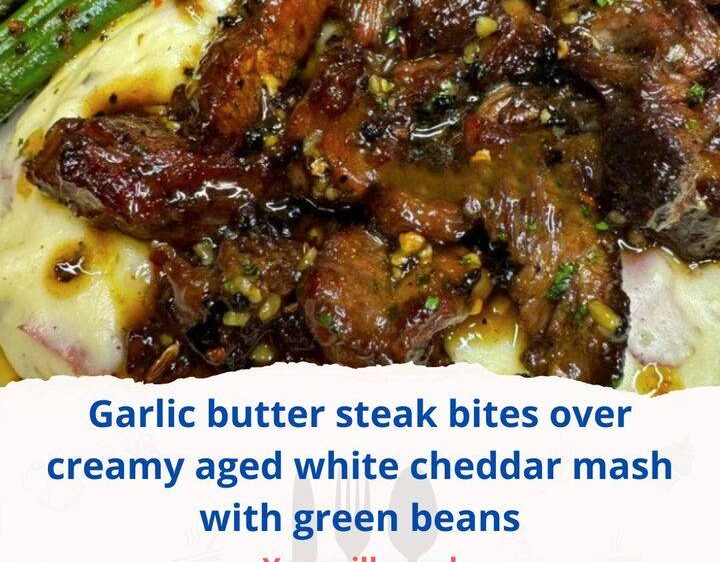 Garlic butter steak bites over creamy aged white cheddar mash with green beans