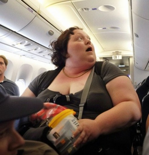 When the captain’s voice is heard speaking to the poor, heavy woman on the plane, the rich man mocks her.